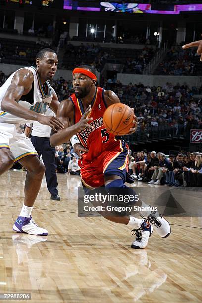 Baron Davis of the Golden State Warriors drives around Rasual Butler of the New Orleans/Oklahoma City Hornets during the game at the Ford Center in...