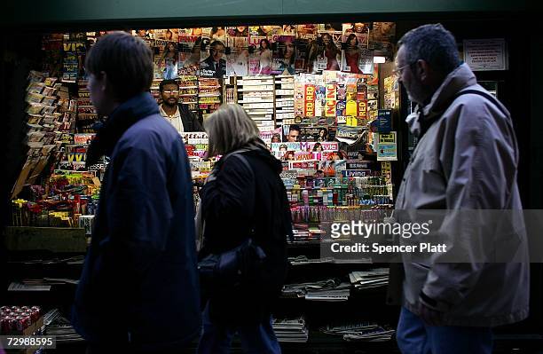People walk by a newsstand on 42nd Street January 12, 2007 in New York City. Citing population migration patterns and growth rates, United Nations...