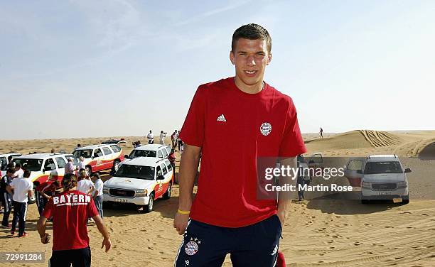 Lukas Podolski of Munich poses in front of the Jeeps during the Bayern Munich desert tour on January 13, 2007 in Dubai, United Arab Emirates.