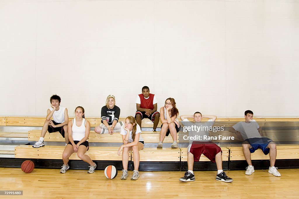 Group of students (16-19) sitting on bleachers in school gym