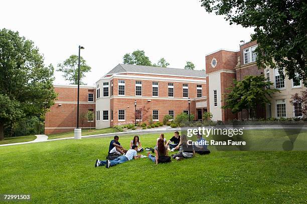 group of friends (16-19) studying outdoors - college campus students stock-fotos und bilder