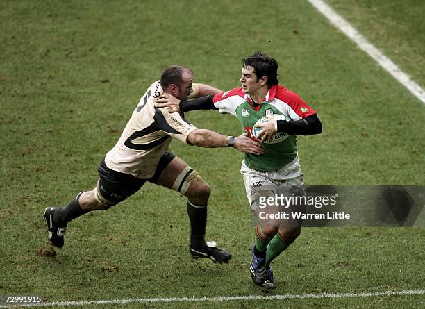 Gonzalo Tiesi of London Irish is tackled by Trevor Brennan of Toulouse during the Heineken Cup round five match between London Irish and Toulouse at...