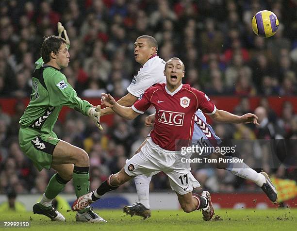 Henrik Larsson of Manchester United clashes with Wilfred Bouma of Aston Villa during the Barclays Premiership match between Manchester United and...