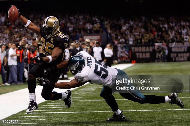 Dhani Jones of the Philadelphia Eagles fails to stop Reggie Bush of the New Orleans Saints from scoring a touchdown during the NFC divisional playoff...