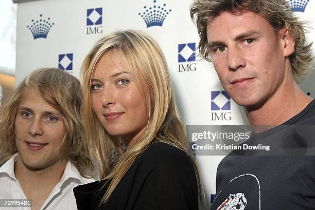 Tennis player Maria Sharapova of Russia poses with AFL players Gary Ablett and Justin Koschitzke at the IMG Tennis Party ahead of the Australian...