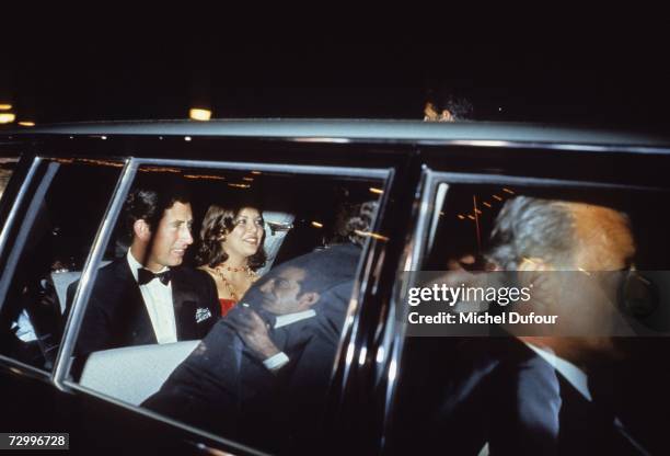 Princess Caroline of Monaco, a member of the Grimaldi family, rides in a car with Prince Charles, Prince of Wales, 1975 in Paris, France. Princess...