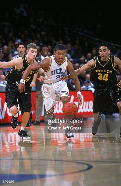 Earl Watson of the University of Southern California Los Angeles Bruins runs with the ball as Anthony Norwood of the Oregon Ducks gaurds him during...