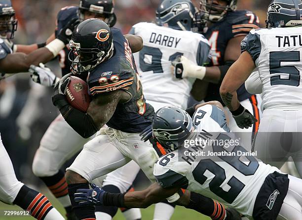 Thomas Jones of the Chicago Bears runs for a touchdown past Ken Hamlin of the Seattle Seahawks in the first quarter of their NFC Divisional Playoff...