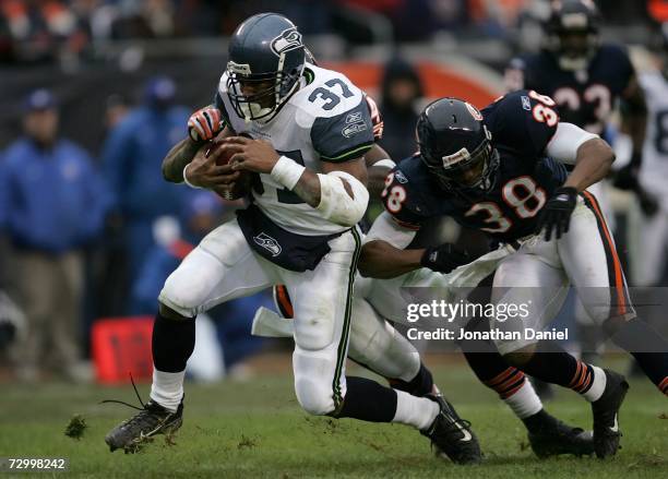 Shaun Alexander of the Seattle Seahawks scores a touchdown on a 13 yard run getting past Danieal Manning of the Chicago Bears during their NFC...