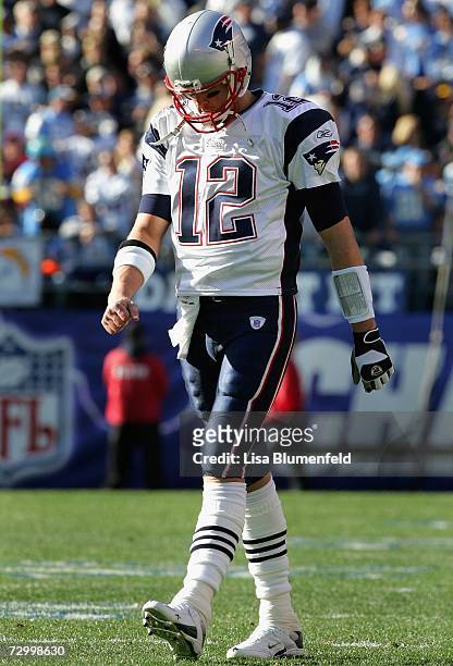 Quarterback Tom Brady of the New England Patriots walks out onto the field during the AFC divisional playoff game against the San Diego Chargers held...