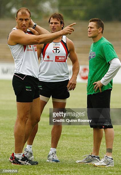 Fraser Gehrig and Aaron Hamill of the Saints talks with Australian super-middleweight boxer Danny Green during a Saint Kilda Saints AFL training...