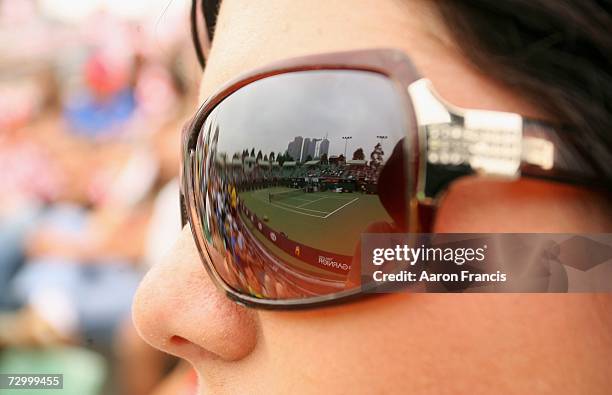 General of view of the action is seen refelcted in the glasses of a spectator on day one of the Australian Open 2007 at Melbourne Park on January 15,...