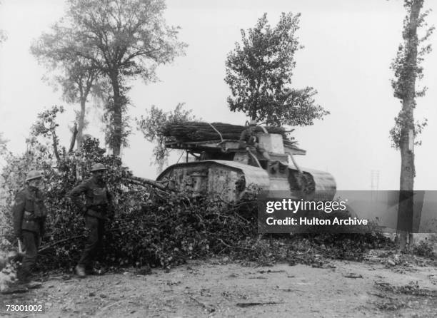 An early British tank, equipped with a wood fascine to aid trench-crossing, Belgium, circa 1917.