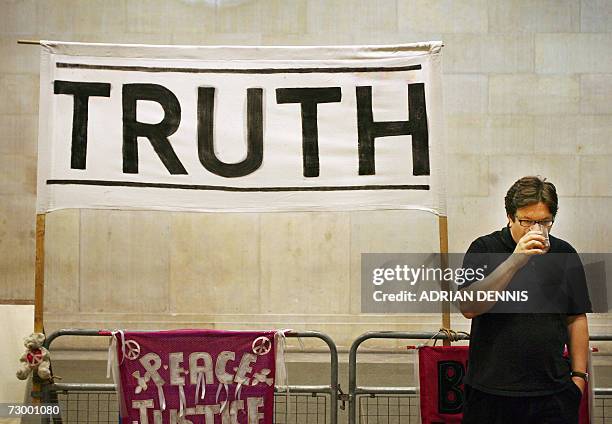 London, UNITED KINGDOM: Artist Mark Wallinger sips from a glass of water beside part of his installation at Tate Britain in London, 15 January 2007....