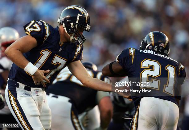 Quarterback Philip Rivers of the San Diego Chargers hands the ball off to running back LaDainian Tomlinson against the New England Patriots in the...