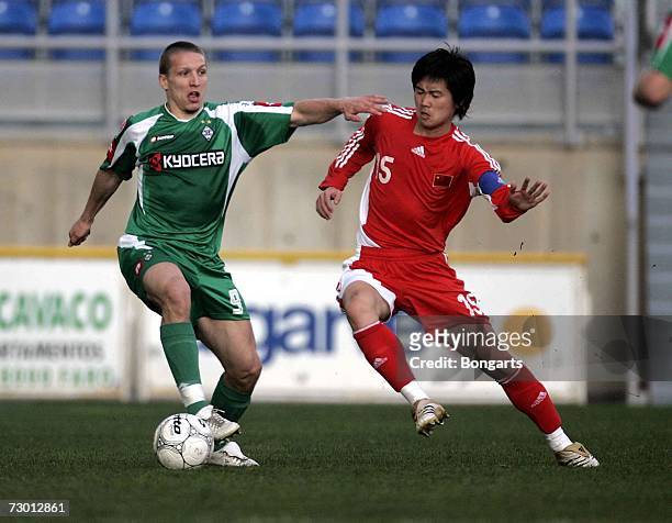 Wesley Sonck of Gladbach and Zheno Tunzhe of team China vie for the ball during the friendly between the National team of China and Borussia...