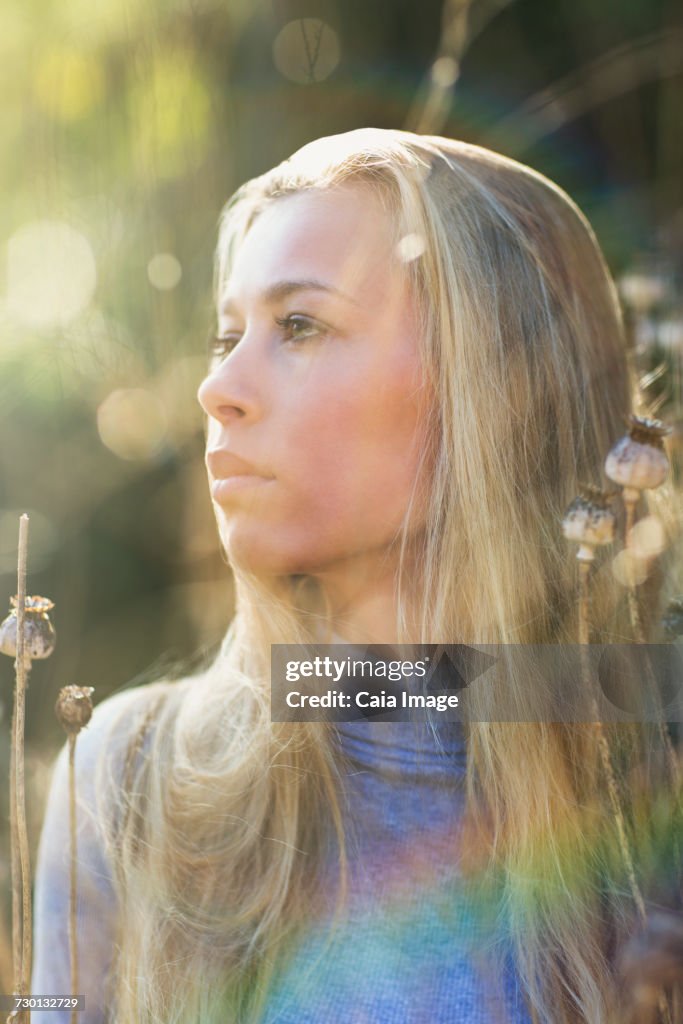 Pensive beautiful blonde teenage girl looking away outdoors