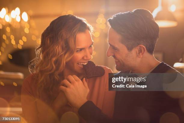 affectionate couple biting heart-shape chocolate cookie - couple chocolate - fotografias e filmes do acervo