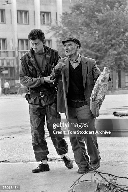 Bosnian fighter ignores the risk from snipers to bravely help an elderly man cross a dangerous intersection on Sniper Alley. During the 47 months...
