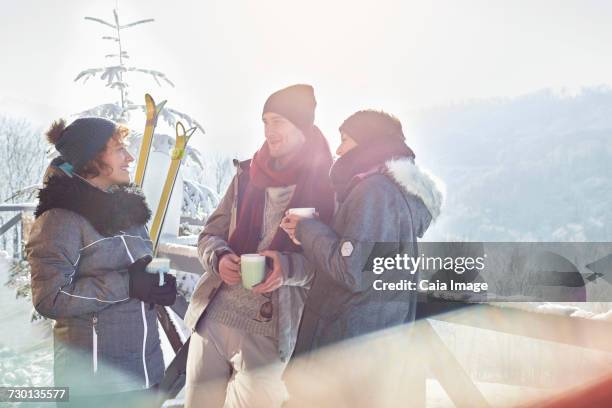 skier friends talking, drinking coffee and hot cocoa apres-ski - hot toddy stockfoto's en -beelden
