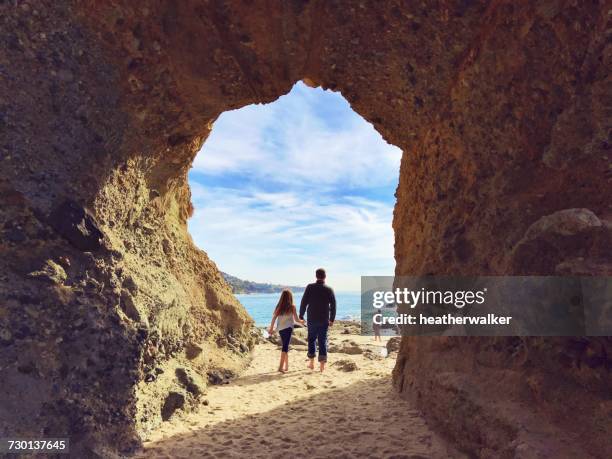 father and daughter on beach walking towards the rest of their family, san diego, california, america, usa - san diego stock-fotos und bilder