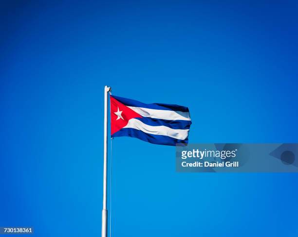 cuba, havana, cuban flag with blue sky - cuban flag ストックフォトと画像