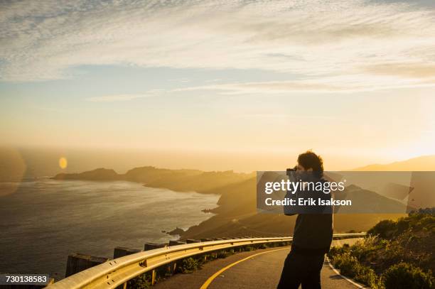 usa, california, san francisco, california, silhouette of man photographing coastline at sunset - photographing sunset stock pictures, royalty-free photos & images