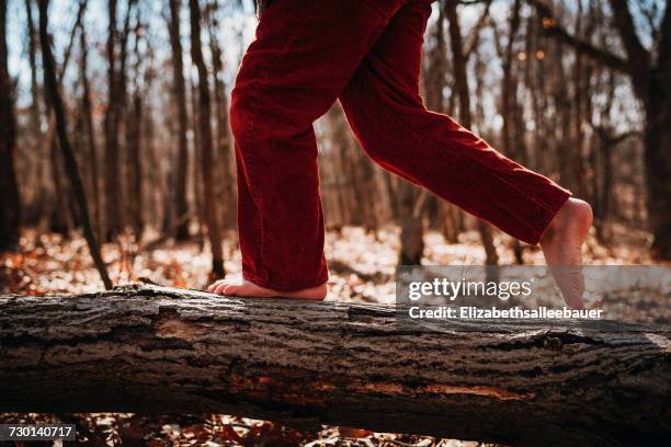 boy running across a log barefoot - barefoot running stock pictures, royalty-free photos & images