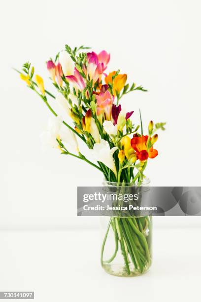 jar with bunch of flowers - freesia flowers stock pictures, royalty-free photos & images