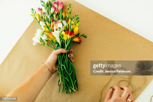 woman making bouquet - freesia stock pictures, royalty-free photos & images