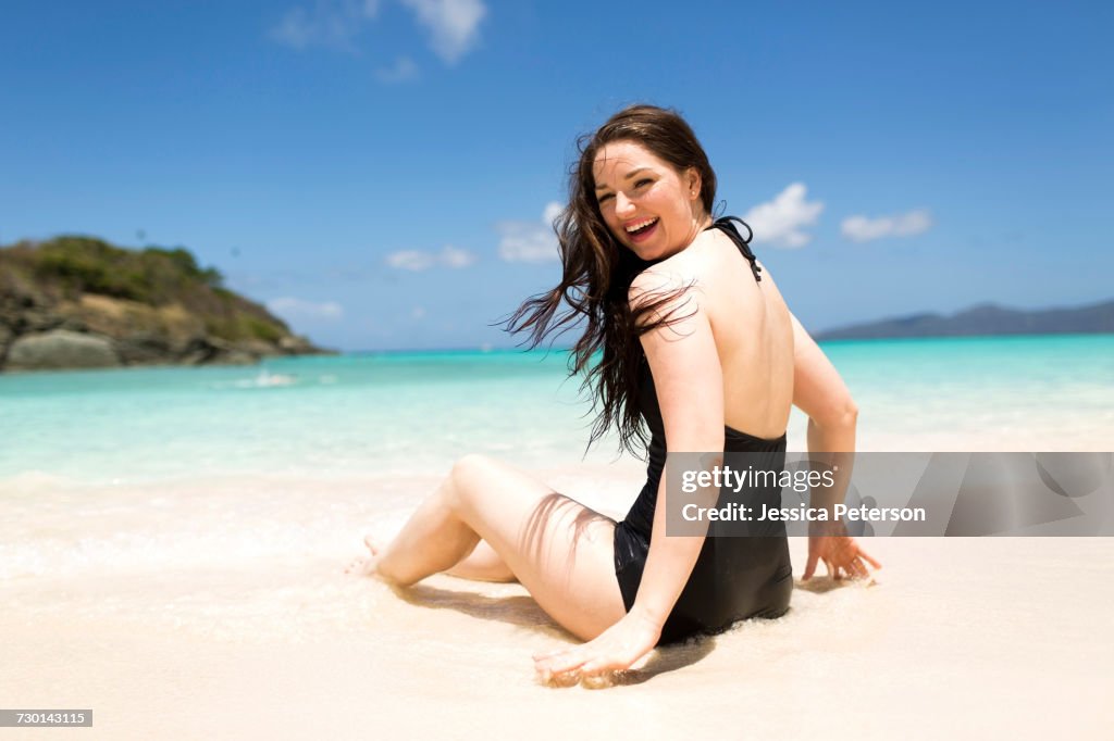 USA, Virgin Islands, Saint Thomas, Beautiful woman sitting on shore