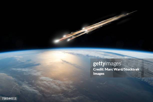 A meteor streaks towards a collision with Earth as it breaks up over the ocean.