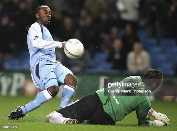 Darius Vassell of Manchester City shoots over Mark Crossley of Sheffield Wednesday during the FA Cup sponsored by E.ON Third Round replay match...