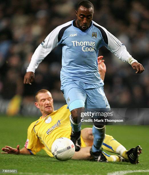 Darius Vassell of Manchester City is tackled by Lee Bullen of Sheffield Wednesday during the FA Cup sponsored by E.ON Third Round replay match...