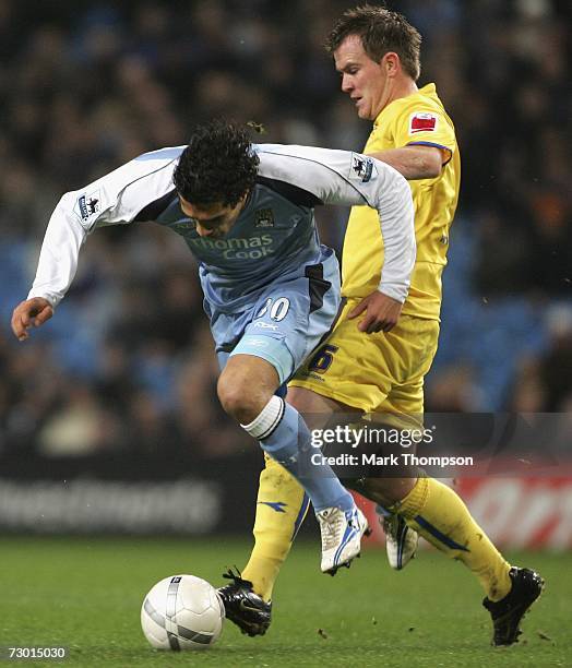 Bernardo Corradi of Manchester City is tackled by Glen Whelan of Sheffield Wednesday during the FA Cup sponsored by E.ON Third Round replay match...