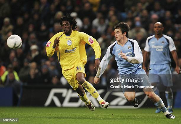 Joey Barton of Manchester City tangles with Yoanne Folly of Sheffield Wednesday during the FA Cup sponsored by E.ON Third Round replay match between...