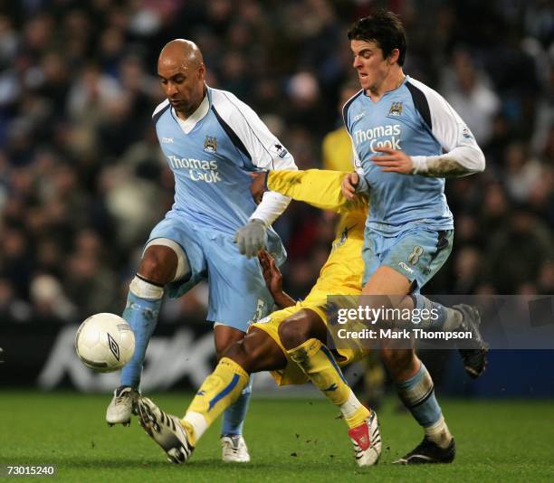Ousmane Dabo and Joey Barton of Manchester City clash with Yoanne Folly of Sheffield Wednesday during the FA Cup sponsored by E.ON Third Round replay...