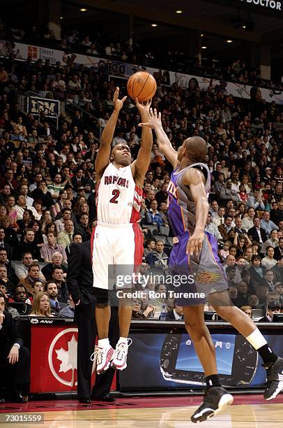 Darrick Martin of the Toronto Raptors shoots over Leandro Barbosa of the Phoenix Suns during the game at Air Canada Centre on January 3, 2007 in...