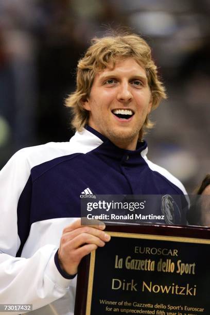 Forward Dirk Nowitzki of the Dallas Mavericks receives an award from La Gazzetta dello Sport before a game against the Houston Rockets on January 16,...