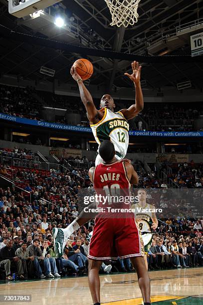 Damien Wilkins of the Seattle SuperSonics goes to the basket over the defense of Damon Jones of the Cleveland Cavaliers on January 16, 2007 at the...