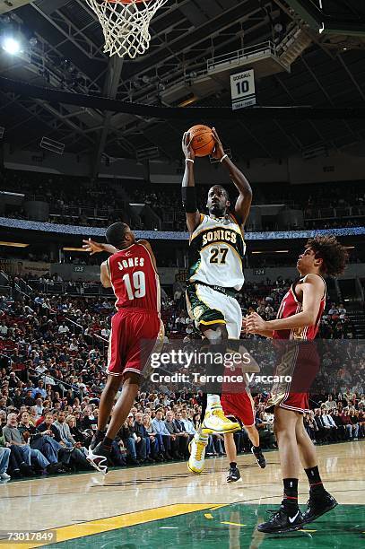 Johan Petro of the Seattle SuperSonics goes to the basket over the defense of Damon Jones of the Cleveland Cavaliers on January 16, 2007 at the Key...