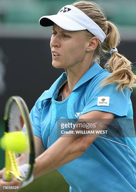 Elena Dementieva of Russia hits a return against Martina Muller of Germany in their women's singles second round match at the Australian Open tennis...