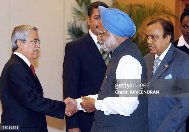 Indian Prime Minister Manmohan Singh shakes hands with Saudi Arabian Oil Minister Ali al- Naimi as Indian Petroleum and Natural Gas Murali Deora...