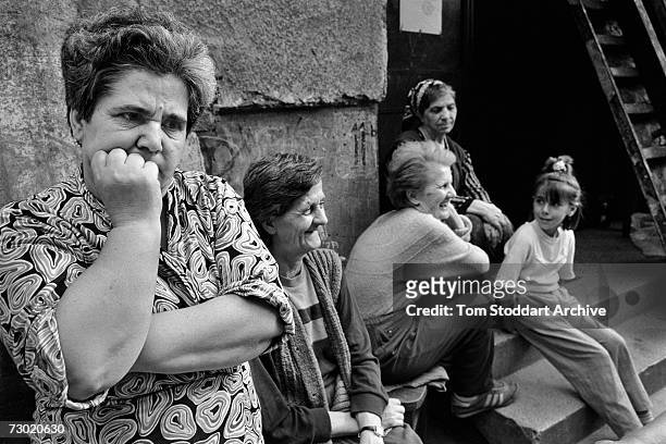 Mothers and children sit talking outside an apartment block during a break in shelling. During the 47 months between the spring of 1992 and February...
