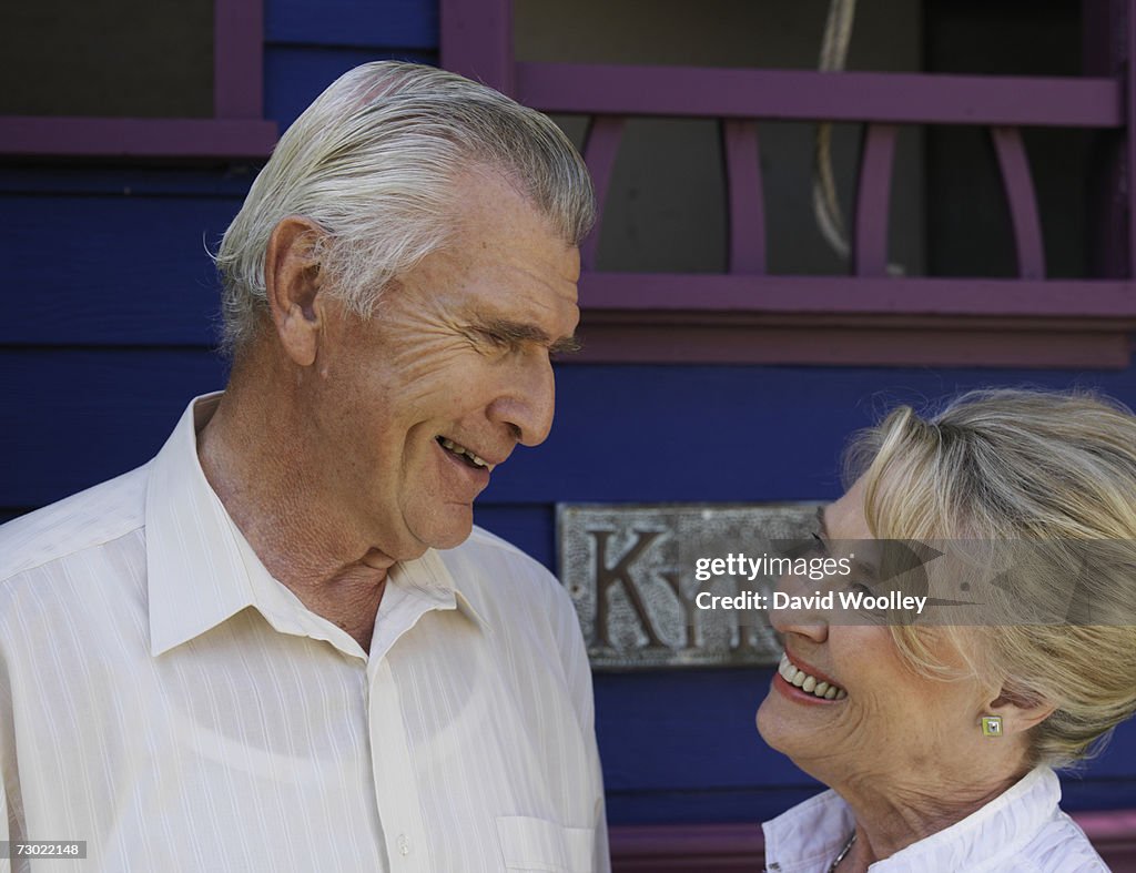 "Senior couple looking in eyes, smiling in garden"