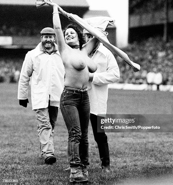 Stewards at Twickenham Stadium, London, approach streaker Erica Roe after she ran onto the pitch topless at half time during an England Vs Australia...