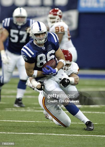 Tight end Ben Utecht of the Indianapolis Colts is tackled by linebacker Kawika Mitchell of the Kansas City Chiefs in a game at the RCA Dome on...