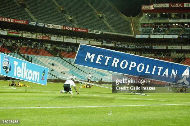 Players are injured as strong winds blow advertising boards onto the pitch during the PSL match between the Orlando Pirates and the Black Leopards at...