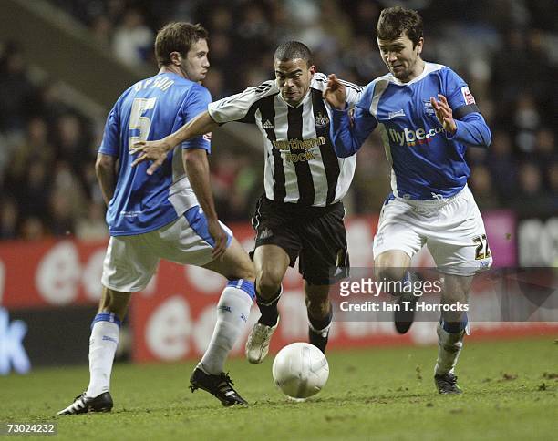 Keiron Dyer tries to get past Mathew Upson and Damien Johnson during the FA Cup sponsored by E.ON Third Round Replay between Newcastle United and...