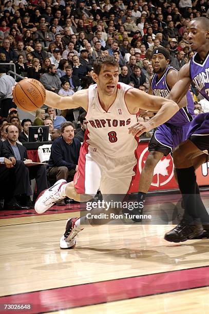 Jose Calderon of the Toronto Raptors drives against Justin Williams of the Sacramento Kings on January 17, 2007 at the Air Canada Centre in Toronto,...